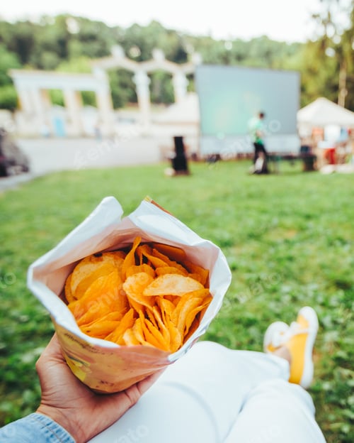 Preview: Man Hands Holding Chips Eating While Watching Movie In Open Air Cinema Couple Covered With Blanket