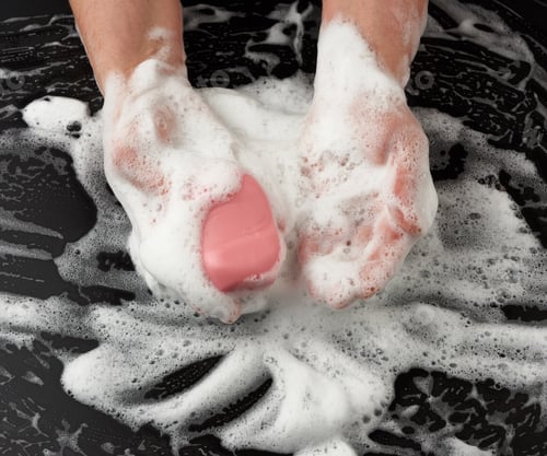 Preview: Process Of Washing Hands With Pink Soap, Parts Of The Body In White Foam On A Black Background, Top
