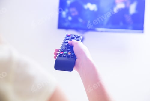 Preview: Woman Is Holding The Remote Control In Her Hands. Using Tv At Home.