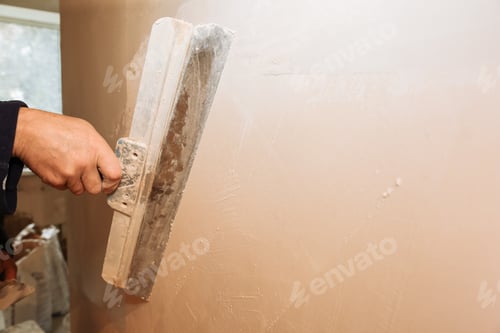 Preview: Man Is Priming A Surface With A Palett Knife. Maintenance Repair Works Renovation In The Flat