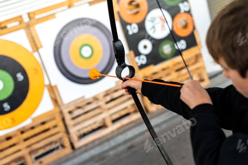 Preview: Boy Aiming With A Training Bow At A Bullseye At A Fair.