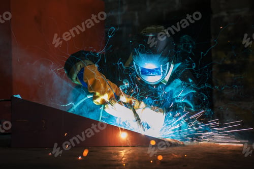 Preview: Worker Welding Metal With Sparks At Factory