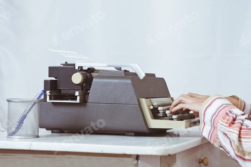 Preview: Man Typing On Antique Typewriter
