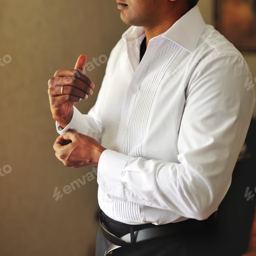 Preview: Man in White Shirt Fastening Cufflinks at Home