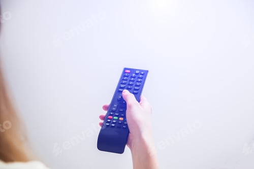 Preview: Woman Is Holding The Remote Control In Her Hands. Using Tv At Home.
