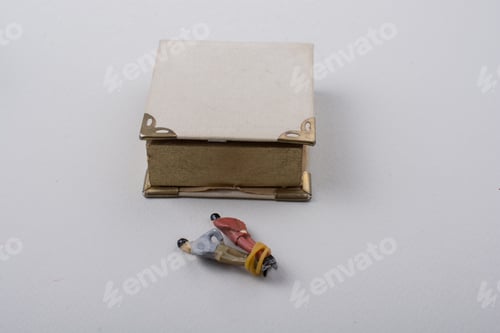 Preview: Tiny Figurine Of Men Model Tied In Rope Beside A Book