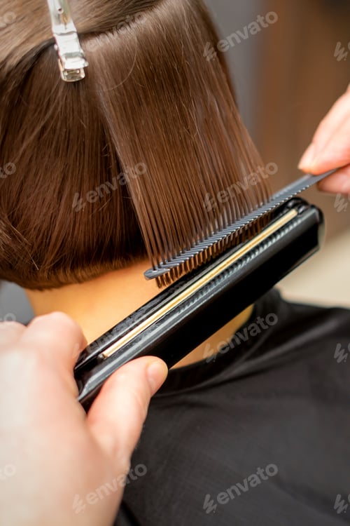 Preview: Close Up Of The Hairdresser Straightening The Short Hair Of A Female Client With A Hair