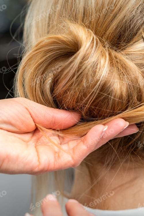Preview: Close Up Of Hands Of Female Hairdresser Styling Hair Of A Blonde Woman In A Hair Salon
