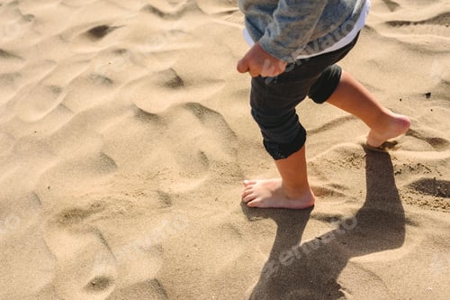 Preview: Feet Of Boy Walking On The Sand Of The Beach.