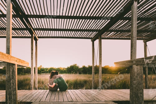 Preview: Couple Hugging Each Other In Love While They Relax Watching The Nature At Sunset.