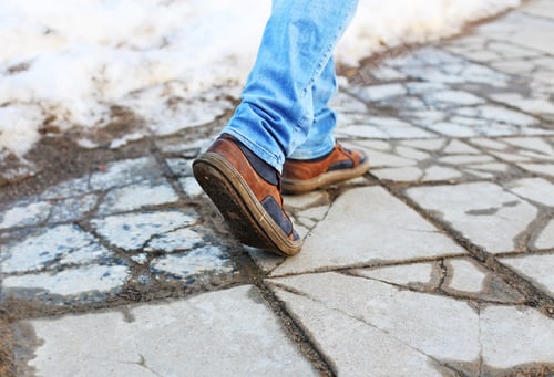 Preview: Male Feet In Jeans And Leather Boots Walking On A Concrete Pavement