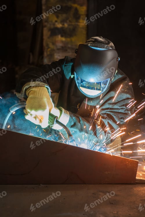 Preview: Worker Welding Metal With Sparks At Factory