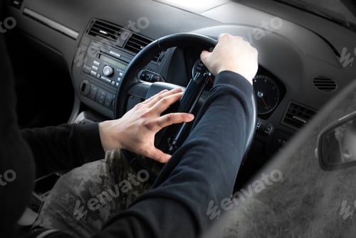Preview: Theft Of The Car. Man With Gun Behind The Wheel. Carjacking Of Vehicle. Robbing And Crime.