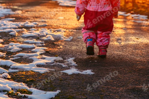 Preview: Young Little Toddler Girl Walking By City Park On Sunset. View From Behind. Playing Outdoors