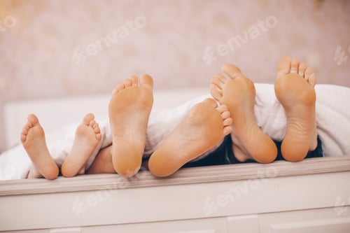 Preview: People, Family And Morning Concept - Bare Soles Or Feet Of Parents And Child In Bed At Home