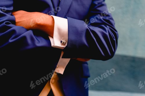 Preview: Crossed Arms Of Businessman With Blue Suit.