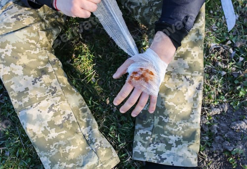 Preview: Man Is Putting Bandage On Bleeding Wound. Injured Hand. Cut With A Knife. Tourist In The Nature