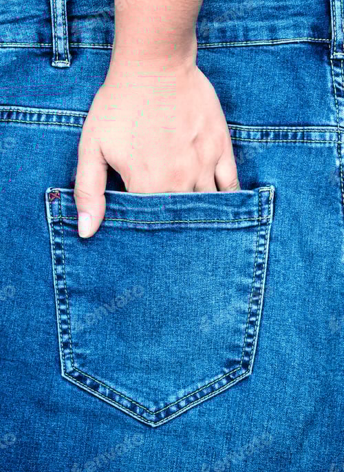 Preview: Female Hand Is Stuck In The Back Pocket Of Blue Jeans, Close Up, Full Frame