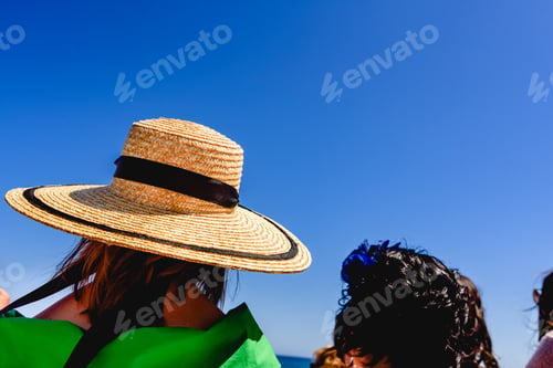 Preview: Woman With A Wide Straw Hat To Protect Herself From The Sun, Elegantly Dressed, During An Outdoor