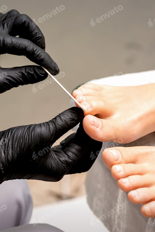 Preview: Pedicure Master'S Hands In Protective Rubber Gloves File Female Toenails With A Nail File In A
