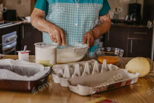 Preview: Adult Woman In The Kitchen Kneading The Mix For Sweets And Desserts