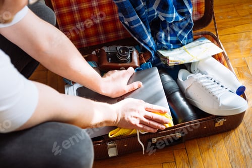 Preview: Travel Concept. Man Put Stuff In Suitcase. Overloaded Bag With Clothes