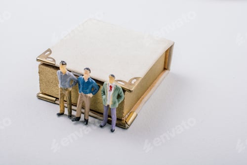 Preview: Tiny Figurine Of Men Models Found Beside A Book