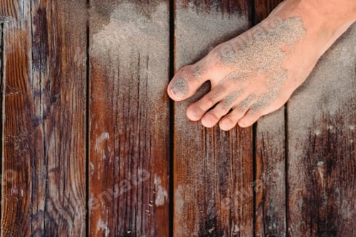 Preview: Foot Stained With Beach Sand On Some Wooden Boards In Summer.