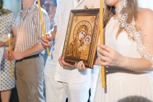 Preview: Newlyweds Holding Icon In Frame At Church Ceremony