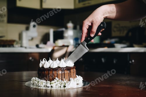 Preview: Hand Cut With Knife Piece Of Cake On Wooden Table