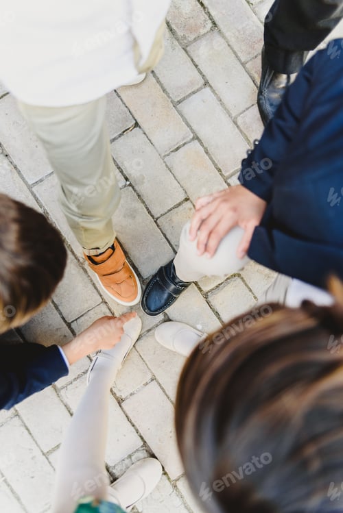Preview: Group Of Children Playing With Their Feet And Shoes In The Center.