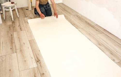 Preview: Man Is Holding Roll Wallpaper In Hands On Floor. Maintenance Repair Works Renovation In The Flat