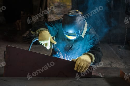 Preview: Worker Welding Metal With Sparks At Factory