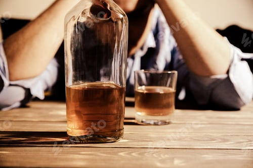 Preview: Alcoholic Addict. Man Near The Table With Alcohol And A Glass. Dangerous Habit. Unhealthy Life