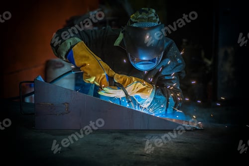 Preview: Worker Welding Metal With Sparks At Factory