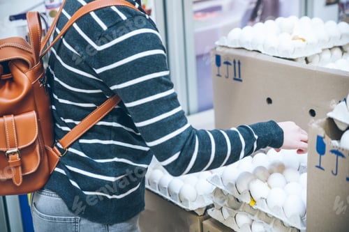 Preview: Woman Put Solid Eggs Into Egg Tray In Grocery Store