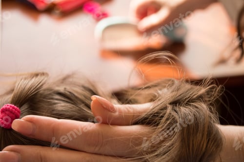 Preview: Mother Combing Her Daughter'S Hair. Hair In Hand.