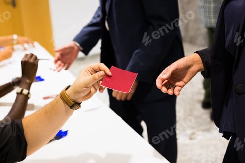 Preview: Woman Hands Out A Blank Red Card In Hand During A Promotional Presentation At A Business Event