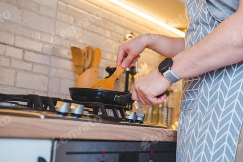 Preview: Man Frying On Pan At The Kitchen. Cooking Concept