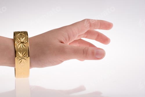Preview: Hand With A Golden Bracelet On A White Background