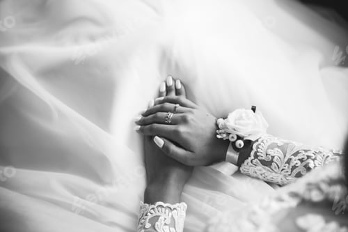 Preview: Bride Is Holding Hands On Knees. Beautiful White Manicure. Engagement Rings On Fingers. Wedding Day