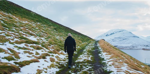 Preview: Hiker Walking A Track On The Snowy Slope Of A Mountain.