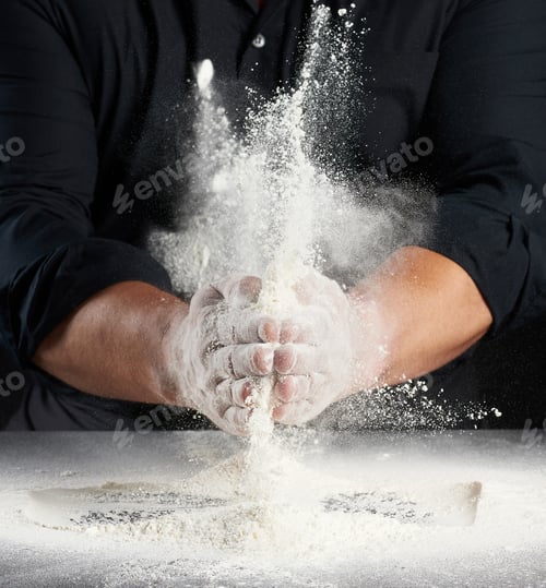 Preview: Man In Black Uniform Sprinkles White Wheat Flour In Different Directions, Product Scatters Dust