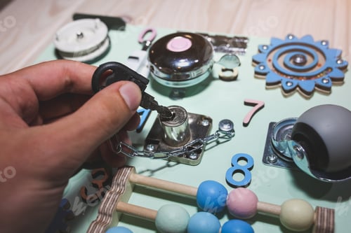 Preview: Man Is Making Children Busy Board With Different Tools For Kids Developing. Eco-Friendly Wooden