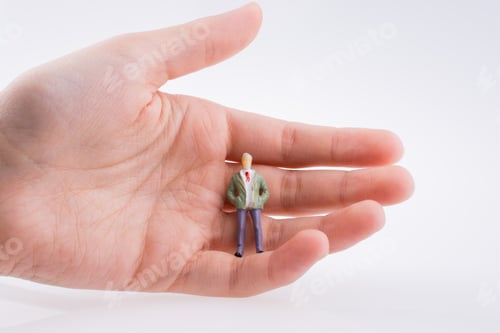 Preview: Hand Holding A Human Figure On A White Background
