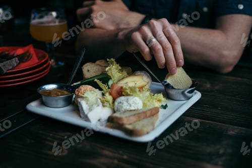 Preview: Hands Taking Snacks From The Plate On Wooden Table In Pub