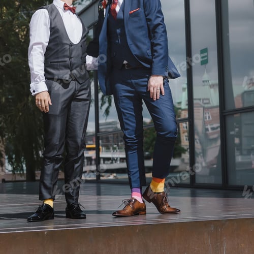 Preview: Homosexual Newlyweds Celebrating Happy Wedding Day Wearing Black And Blue Suits. Equality Concept.