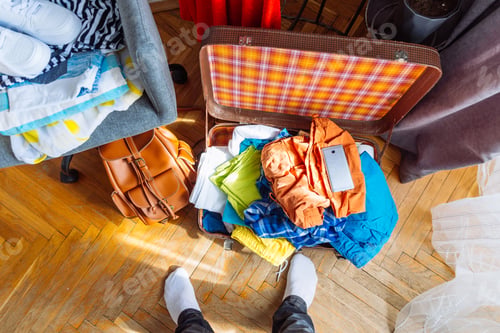 Preview: Overloaded Valise With Clothes. Prepared Garment On Chair. Travel Concept