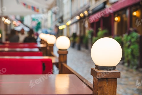 Preview: Outdoors Cafe With Lamp Near Tables. Copy Space