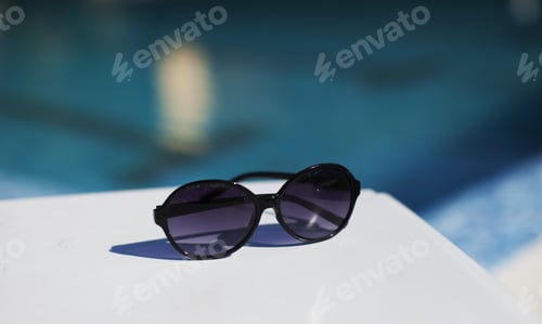 Preview: Black Glasess On White Table Near Wimming Pool